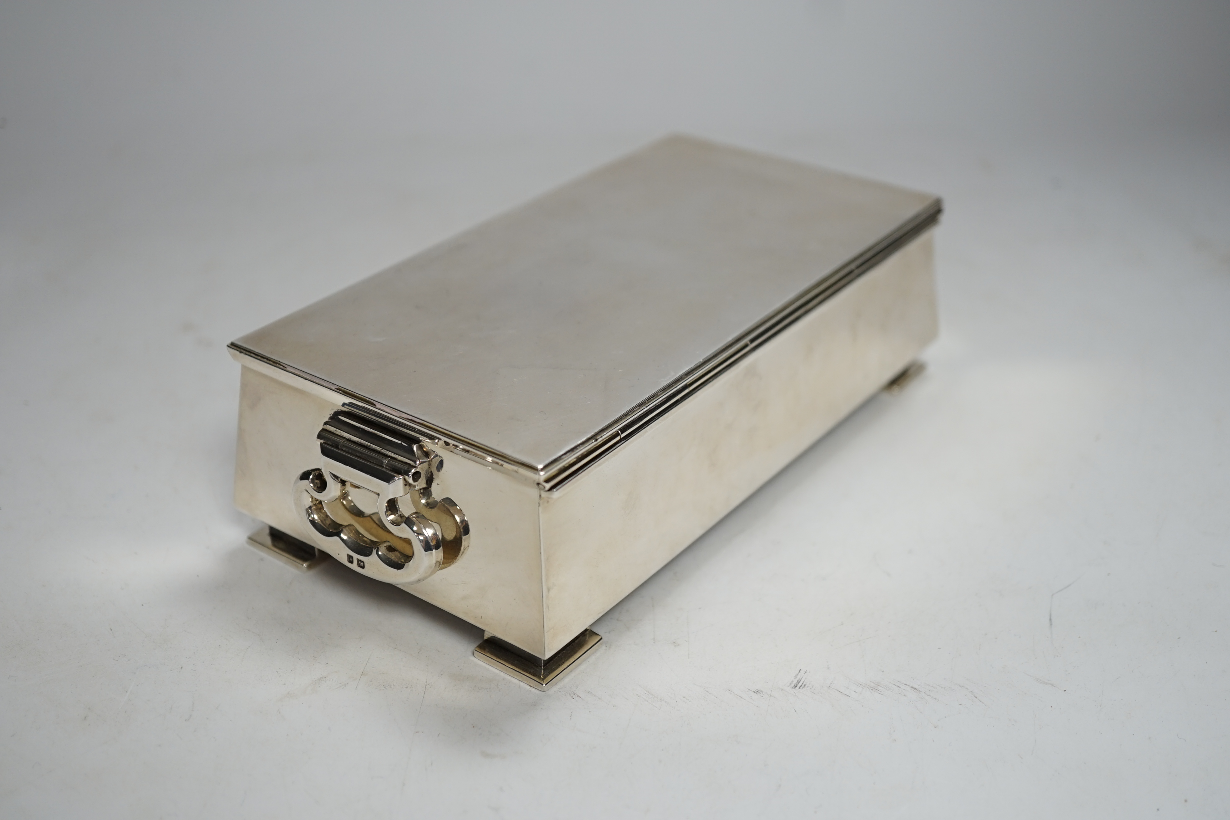A George V Art Deco silver mounted two handled cigarette box, Padgett & Braham Ltd, London, 1935, 18.5cm.